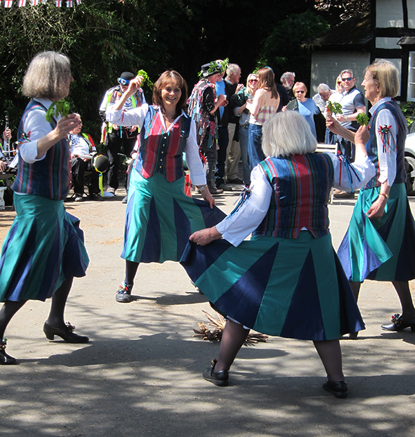 Appleyard traditional dancers in their green red and blue attire, in action