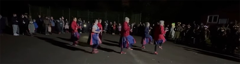 dancing in front of enthusiastic locals in the dark in Wychbold