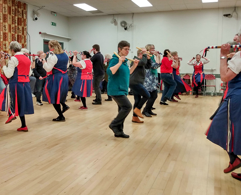 mixed morris and folk dancers in rows learning the Preston morris dance