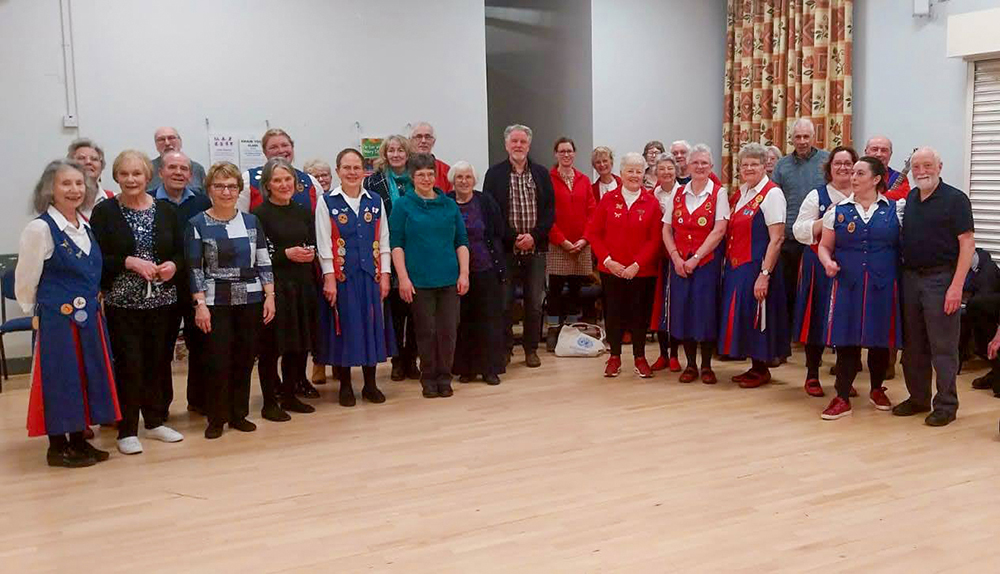 group photograph of both teams standing together