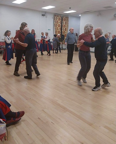 pairs of dancers dancing a folk dance