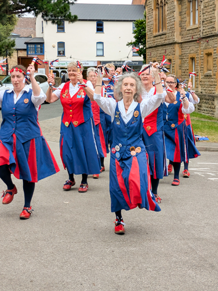 Butterfly dancers in rows of 4 dancing a northwest style dance