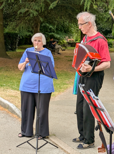 2 Butterfly musicians, lady playing a recorder and gent playing accordion