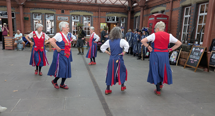 Dancers forming a circle in the Booking Hall at Kidderminster Station