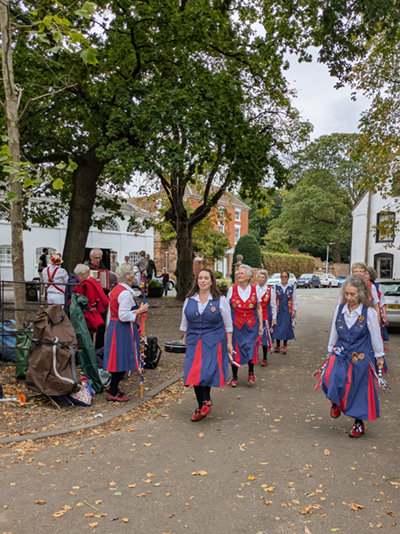 Nancy Butterfly in a set of 8 dancing on a roadway lined with trees in Feckenham.